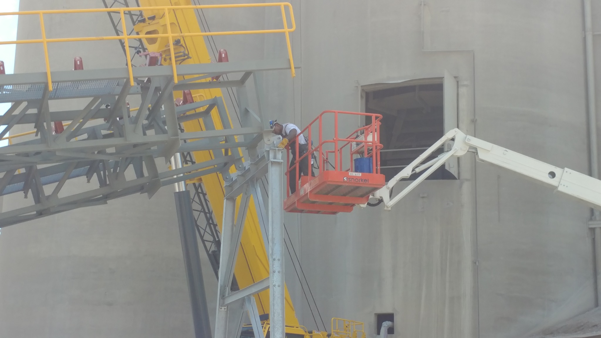 Connection work at an elevated conveyor support.